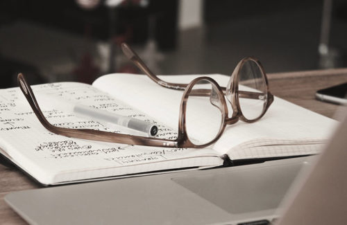 Glasses on a notebook during research